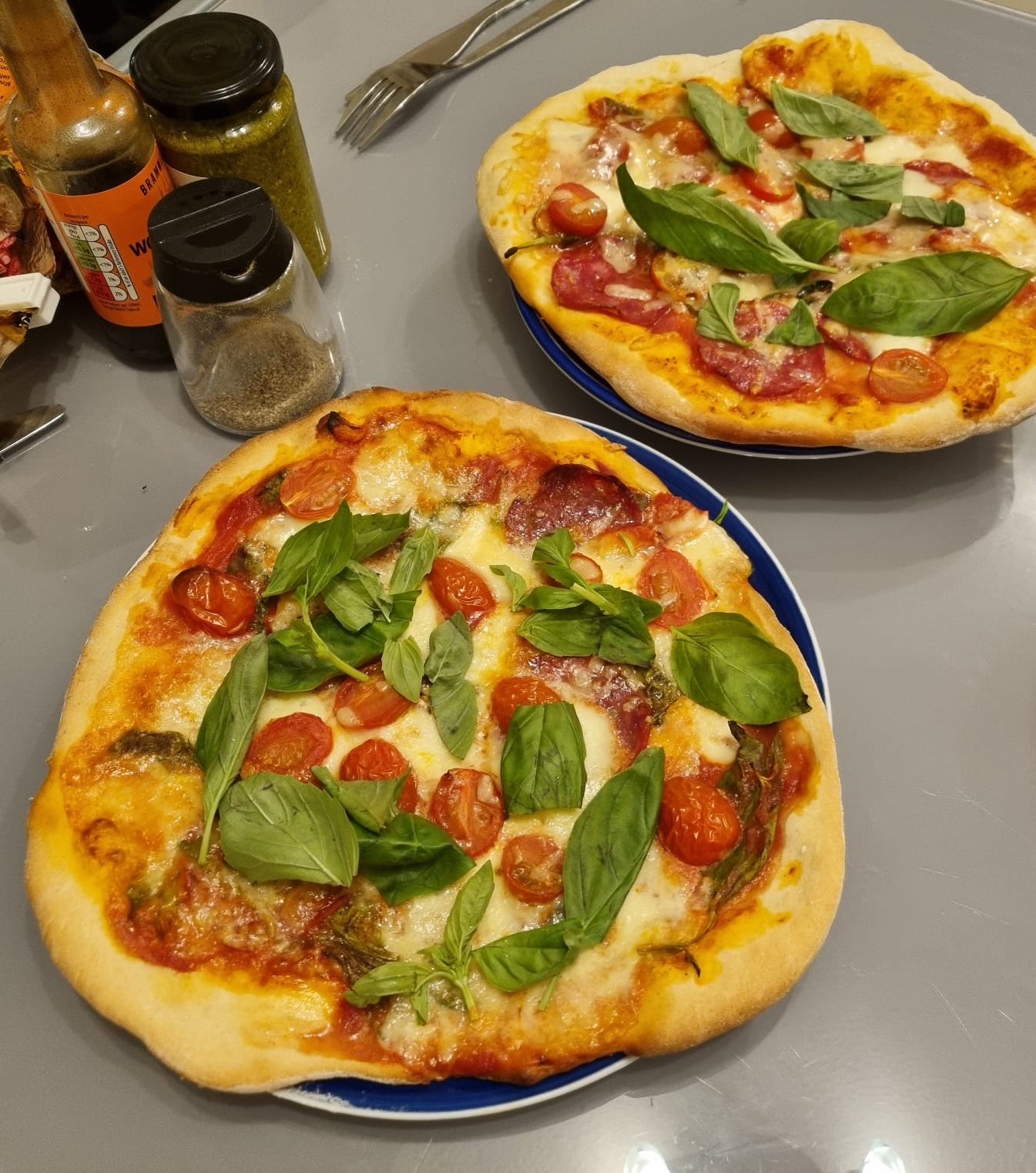 Two delicious-looking cooked pizza