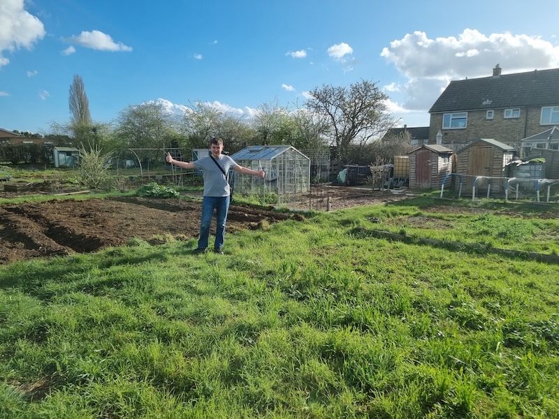 Dan standing on a plot of overgrown grass that was our allotment